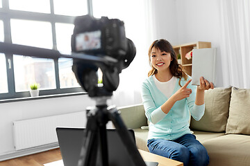 Image showing asian female blogger making video review of book