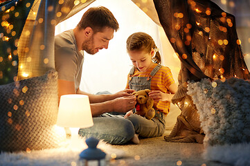 Image showing happy family playing with toy in kids tent at home