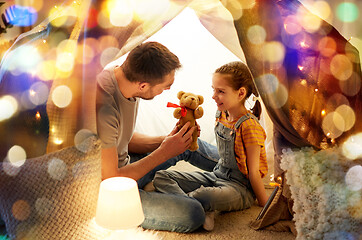 Image showing happy family playing with toy in kids tent at home