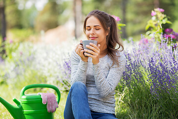 Image showing woman drinking tea or coffee at summer garden