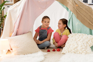 Image showing little girl playing tea party in kids tent at home