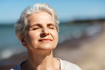 Image showing portrait of senior woman enjoying sun on beach