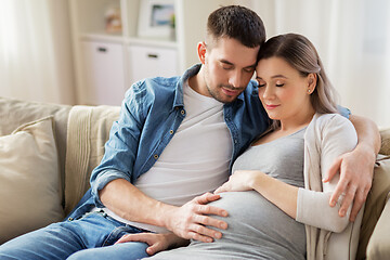 Image showing man hugging pregnant woman at home