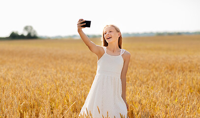 Image showing happy young girl taking selfie by smartphone