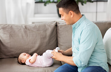 Image showing middle aged father playing with baby at home