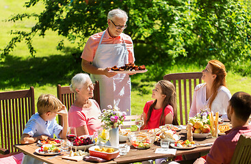 Image showing happy family having dinner or summer garden party