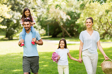 Image showing family with picnic basket walking in summer park
