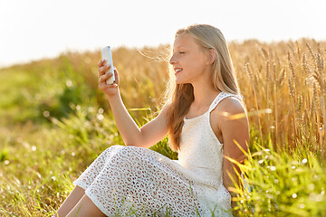 Image showing happy young girl taking selfie by smartphone