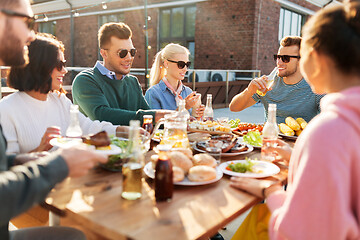 Image showing friends having dinner or bbq party on rooftop