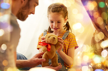 Image showing happy family playing with toy in kids tent at home