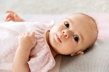 Image showing sweet baby girl lying on knitted blanket