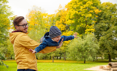 Image showing father with son playing and having fun in autumn