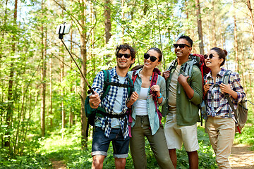 Image showing friends with backpacks hiking and taking selfie