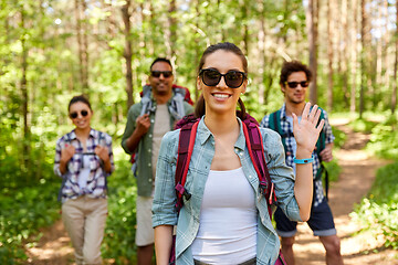 Image showing friends with backpacks on hike in forest