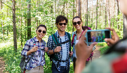 Image showing friends with backpacks being photographed on hike