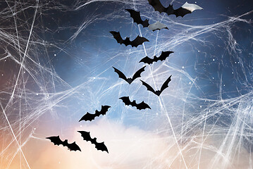 Image showing black bats over starry night sky and spiderweb