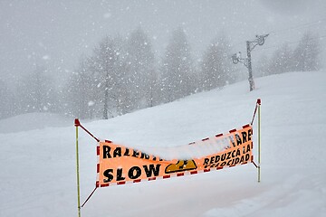 Image showing Ski slop warning sign in heavy snowing