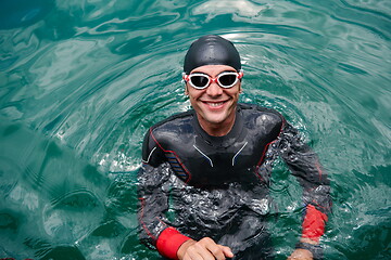 Image showing triathlete swimmer portrait wearing wetsuit on training