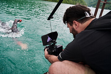Image showing videographer taking action shot of triathlon swimming athlete