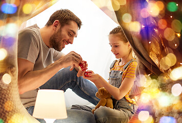 Image showing family playing tea party in kids tent at home