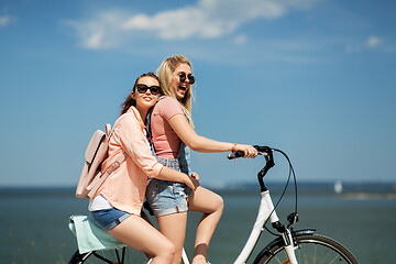 Image showing teenage girls or friends riding bicycle in summer