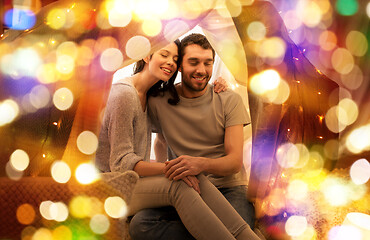 Image showing happy couple in kids tent at home