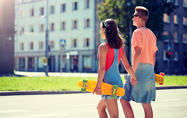 Image showing teenage couple with skateboards on city crosswalk