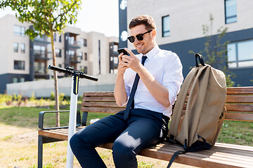 Image showing businessman with smartphone, backpack and scooter