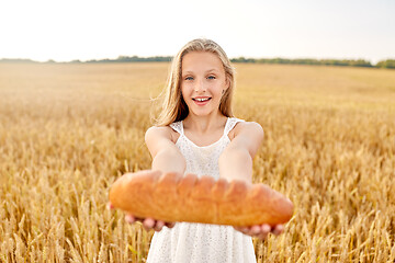 Image showing girl with loaf of white bread on cereal field