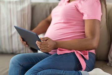 Image showing close up of pregnant woman with tablet pc at home