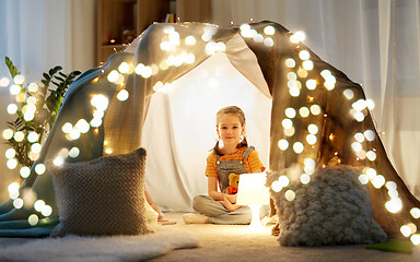 Image showing little girl with toys in kids tent at home