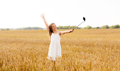 Image showing happy young girl taking selfie by smartphone