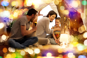 Image showing father telling scary stories to his daughter