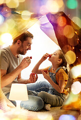 Image showing family playing tea party in kids tent at home