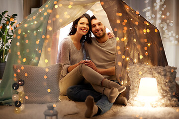Image showing happy couple in kids tent at home