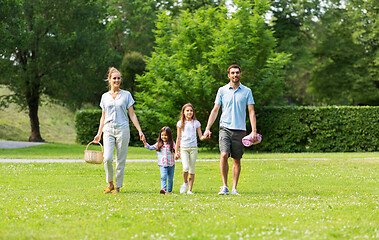 Image showing family with picnic basket walking in summer park