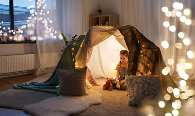 Image showing little girl with toys in kids tent at home