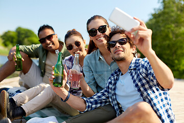 Image showing friends with drinks taking selfie by smartphone