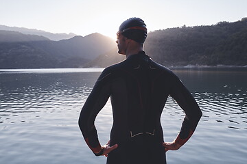 Image showing triathlon athlete starting swimming training on lake