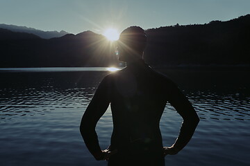 Image showing triathlon athlete starting swimming training on lake