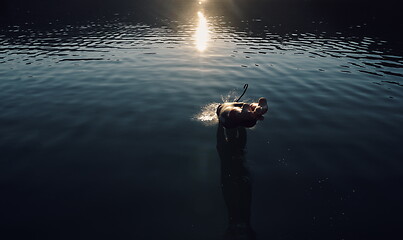 Image showing triathlon athlete jumping in to water and starting with training