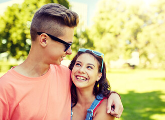 Image showing happy teenage couple looking at each other in park