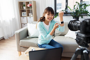 Image showing asian blogger makes video blog of smart watch