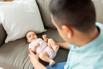 Image showing middle aged father playing with baby at home