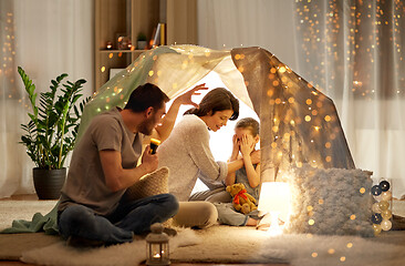 Image showing father telling scary stories to his daughter