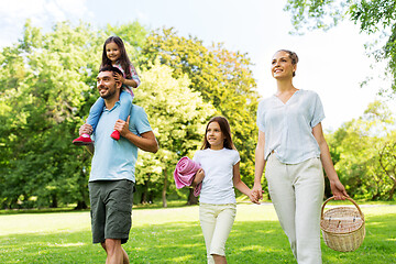 Image showing family with picnic basket walking in summer park