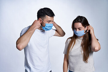 Image showing Young couple wearing medicine masks