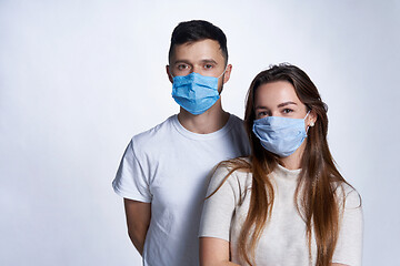 Image showing Young couple wearing medicine masks