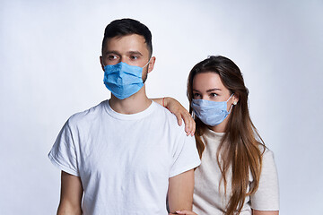 Image showing Young couple wearing medicine masks