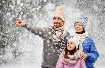 Image showing happy family in winter clothes on snow background